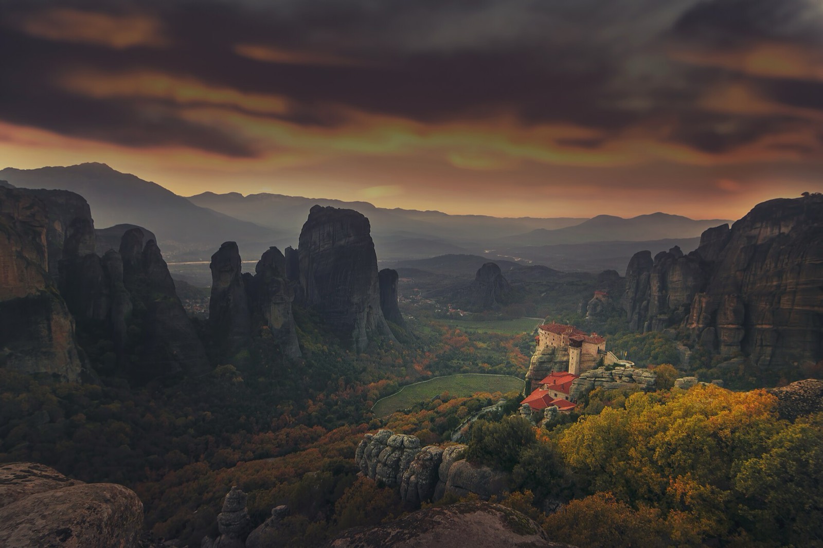 Wide view of several Meteora monasteries on the pillars